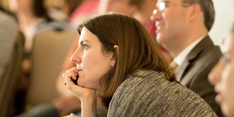 Woman listening to speaker